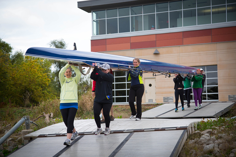 People carrying a boat